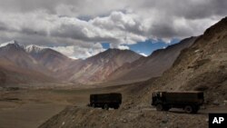 FILE PHOTO: Indian army trucks drive near Pangong Tso lake near the India-China border, Sept. 14, 2017, in India's Ladakh region. (AP Images)