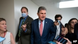 FILE - Senator Joe Manchin, a conservative Democrat representing the state of West Virginia, is surrounded by reporters at the Capitol in Washington, May 26, 2021. 