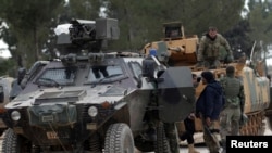 FILE - Turkish forces and members of the Free Syrian Army are seen on the outskirts of al-Bab, Feb. 4, 2017.