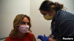 Grace Demars receives a COVID-19 vaccine at North Oaks Medical Center as cases of the COVID-19 surge in Hammond, Louisiana, Aug. 5, 2021. 