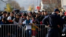 FILE - Migrants wait to register with police at a refugee center in the southern Serbian town of Presevo, Nov. 16, 2015. Newly elected Canadian Prime Minister Justin Trudeau will announce Tuesday his plan to resettle 25,000 Syrian refugees.