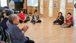 FILE - Women whose families were killed, wounded, or arrested during the Gwangju Uprising sing songs at the May Mothers House community center in Gwangju, South Korea. May 20, 2020. (William Gallo/VOA)