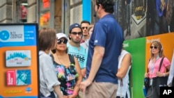 Jean Nebbia (far right), a schoolteacher from Oakland, New Jersey, prepares to join a tour group visiting the Sept. 11 memorial site, Aug. 11, 2016, in New York. 