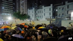 Police shoot tear gas from inside police station to protesters during a protest during a protest in Mong Kok, Hong Kong on Sept. 6, 2019. 
