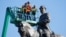 An inspection crew f takes measurements as they inspect the statue of Confederate Gen. Robert E. Lee on Monument Avenue June 8, 2020, in Richmond, Va. Virginia Gov. Ralph Northam has ordered the removal of the statue. 