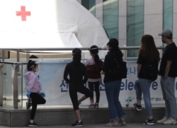 People stand in a line at a testing center for the coronavirus disease (COVID-19) in Seoul, South Korea, May 11, 2020.