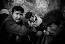 Mohammed Reza, a homeless drug user, smoking methamphetamine under the bridge in Pul e Sukhta area in Kabul. (Maciej Stanik/VOA)