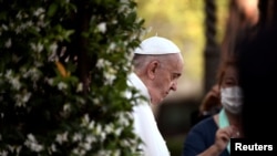 FILE - Pope Francis arrives to lead Holy Rosary prayer in Vatican gardens to end the month of May, at the Vatican, May 31, 2021.