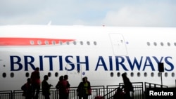 FILE - A British Airways jet arrives at a hanger after landing at Heathrow airport in London July 4, 2013. 
