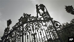 A worker makes repairs to a fence outside the People's Assembly as final preparations are made for the opening session January 23 of the first post-Hosni Mubarak parliament session, several days ahead of the one-year anniversary of Egypt's revolution, in 