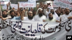 In this Sept. 7, 2018 file photo, Pakistani Islamists protest the appointment of a minority Ahmadi Muslim as an adviser to the government, in Lahore, Pakistan.