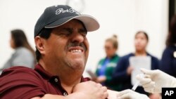 Cesar Gonzalez gets a flu shot at Eastfield College in Mesquite, Texas, Jan. 23, 2020. According to the Dallas County Health and Human Services Department, who offered the free shots, Dallas County reported its 11th flu-related death this season.
