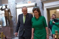 FILE - Senate Minority Leader Sen. Chuck Schumer of N.Y., and House Speaker Nancy Pelosi of Calif., walk on Capitol Hill in Washington, March 12, 2020.