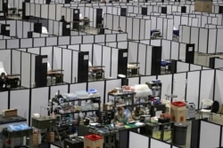 Soldiers work at a nursing station in the intensive care section of a military field hospital at the CenturyLink Field Event Center in Seattle, Washington, April 5, 2020.