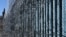Border wall reinforced with barbed wire to prevent migrants from illegally entering into the United States. 