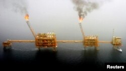 FILE - Gas flares from an oil production platform at the Soroush oil fields in the Persian Gulf, south of Tehran, July 25, 2005.