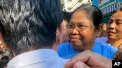 Than Myint Aung, center, a prominent philanthropist and writer, is welcomed by her colleagues after she was released from Insein prison, in Yangon, Myanmar, Jan. 4, 2023.
