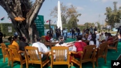 FILE - Myanmar State Counselor Aung San Suu Kyi, center, attends a peace discussion with ethnic representatives during Union Day celebrations in Panglong, Myanmar, Feb. 12, 2017.