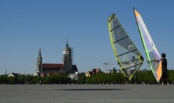 FILE - People wind-skate at the Theresienwiese, site of the annual Oktoberfest beer festival in Munich, southern Germany, April 23, 2020. This year's Oktoberfest has already been cancelled due to the coronavirus pandemic.