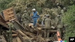 Japan's Ground Self-Defense Force soldiers run a rescue operation in Kiho, Mie Prefecture, Sept. 5, 2011.
