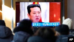 People watch a TV screen showing an image of North Korean leader Kim Jong Un at the Seoul Railway Station in Seoul, South Korea, Jan. 1, 2022.