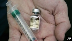 FILE - A doctor holds a vial of the human papillomavirus vaccine Gardasil in his Chicago, Illinois,, office. The southwestern African nation of Namibia is struggling with its rollout of the human papillomavirus vaccine.