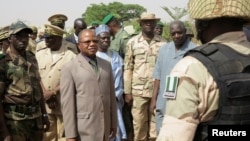 Mali's Prime Minister Diango Cissoko (3rd L) reviews Nigerian soldiers at their base in the town of Banamba,150km (93 miles) from Bamako, April 9, 2013.
