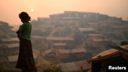 FILE - A Rohingya woman is seen at Balukhali refugee camp at dawn near Cox's Bazaar, Bangladesh, March 28, 2018. 