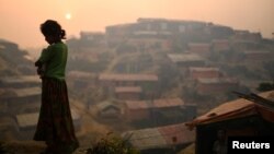FILE - A Rohingya refugee is seen in Balukhali refugee camp at dawn near Cox's Bazaar, Bangladesh, March 28, 2018. 