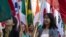 FILE - International students carry their national flags at the University of Missouri in Columbia, Mo.