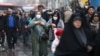 FILE - Iranian women wear masks to prevent against the coronavirus as they walk at Grand Bazaar in Tehran, Iran, Feb. 20, 2020. (West Asia News Agency/Nazanin Tabatabaee via Reuters)