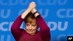 German Chancellor and party chairwoman Angela Merkel acknowledges the applause of the delegates after her speech during the party convention of the Christian Democratic Union CDU in Berlin, Germany, Monday, Feb. 26, 2018.