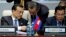 Chinese Premier Li Keqiang, left, talks with Foreign Minister Wang Yi, center, as he and Cambodia's Prime Minister Hun Sen, right, attend the opening session of the Asia-Europe Meeting summit in Ulaanbaatar, Mongolia, July 15, 2016. 