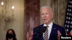 FILE - President Joe Biden delivers a foreign policy address as Vice President Kamala Harris listens, at the State Department in Washington, Feb. 4, 2021.