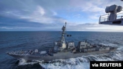 The U.S. Navy Arleigh Burke-class guided-missile destroyer USS Kidd transits alongside the aircraft carrier USS Theodore Roosevelt while participating in Exercise Northern Edge 2019 in the Gulf of Alaska, May 16, 2019. 