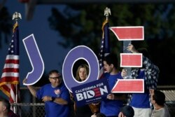 Supporters hold a sign before a campaign rally for Democratic presidential candidate former Vice President Joe Biden, March 3, 2020, in Los Angeles.