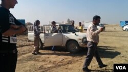 Homeowners from villages where Islamic State fighters have been driven out in recent days return to visit and gather any of their possessions that remain, despite the danger of hidden bombs in the villages, in Iraq's Kazir province, Oct. 22, 2016. (H. Mur