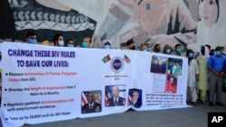 IIn this June 25, 2021 photo, former Afghan interpreters hold placards during demonstrations in front of the US Embassy in Kabul. The Biden administration says it will evacuate about 2,500 Afghans who worked for the U.S. government and their families.