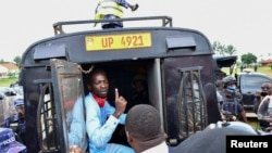Ugandan presidential candidate Robert Kyagulanyi, also known as Bobi Wine, sits inside a police vehicle in Luuka district, eastern Uganda, Nov. 18, 2020. 