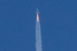 Virgin Galactic's passenger rocket plane VSS Unity, carrying billionaire entrepreneur Richard Branson and his crew, begins its ascent to the edge of space above Spaceport America, near Truth or Consequences, New Mexico, July 11, 2021.
