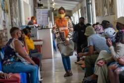 FILE - Volunteers wait at a vaccine trial facility outside Johannesburg, South Africa, Nov. 30, 2020.