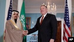 Secretary of State Mike Pompeo, right, shakes hands with Saudi Foreign Minister Faisal bin Farhan Al Saud, Feb. 12, 2020, at the State Department in Washington. 