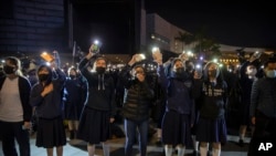 FILE - Protesters wave their smartphones as they sing "Glory to Hong Kong" during a rally for secondary school students near the Hong Kong Museum of Art in Hong Kong, Dec. 13, 2019. 