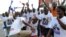 Supporters of Ghana's main opposition candidate Nana Akufo-Addo of the New Patriotic Party dance in the streets of Kasoa, center Ghana.