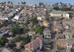 In this photo provided by the Office of Civil Defense, volcanic ash covers most of the roofs at villages in Batangas province, southern Philippines on Jan. 17, 2020.