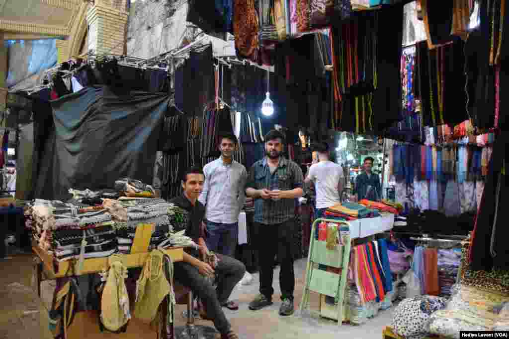 Shop owners prepare to close their stores for the day, in Irbil, Iraq.