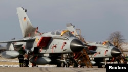 FILE - Tornado fighter jets planes of the reconnaissance squadron 51 "Immelmann" stand on the runway upon arrival at Schleswig airbase in Jagel, near the German-Danish border.