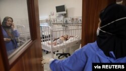 A child lies on a bed at Mofid children's hospital, where children suspected to be infected with the coronavirus disease (COVID-19) are treated, in Tehran, July 8, 2020. (West Asia News Agency/Abdollah Heidari via Reuters) 