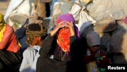 FILE - Displaced Yemenis are seen in a makeshift camp near Sana'a, Yemen, Nov. 17, 2017.