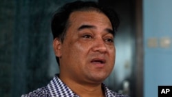 FILE - Outspoken Uighur scholar and advocate Ilham Tohti speaks during an interview at his home in Beijing.